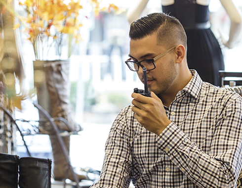Retail sales clerk talking on a Motorola two way radio